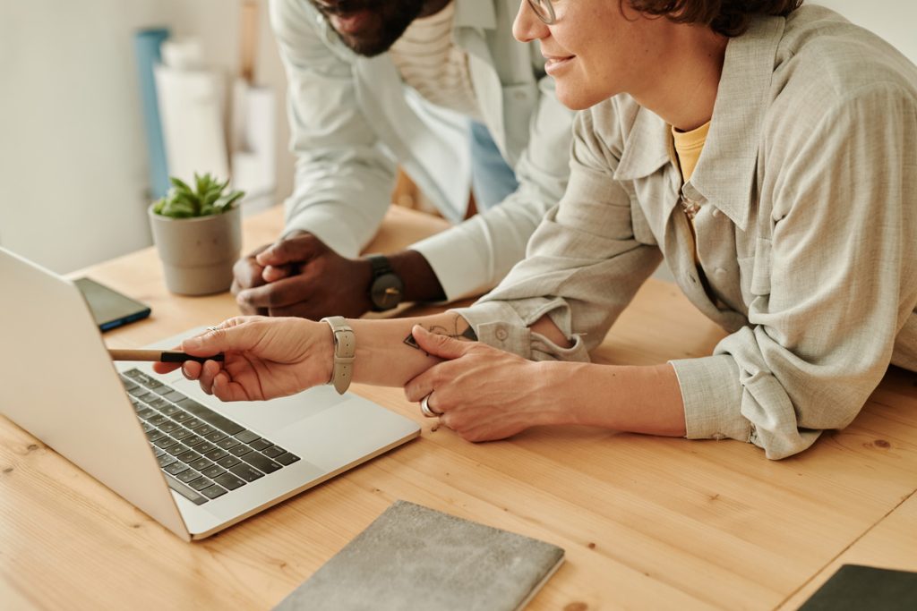 Business people working with online project on laptop